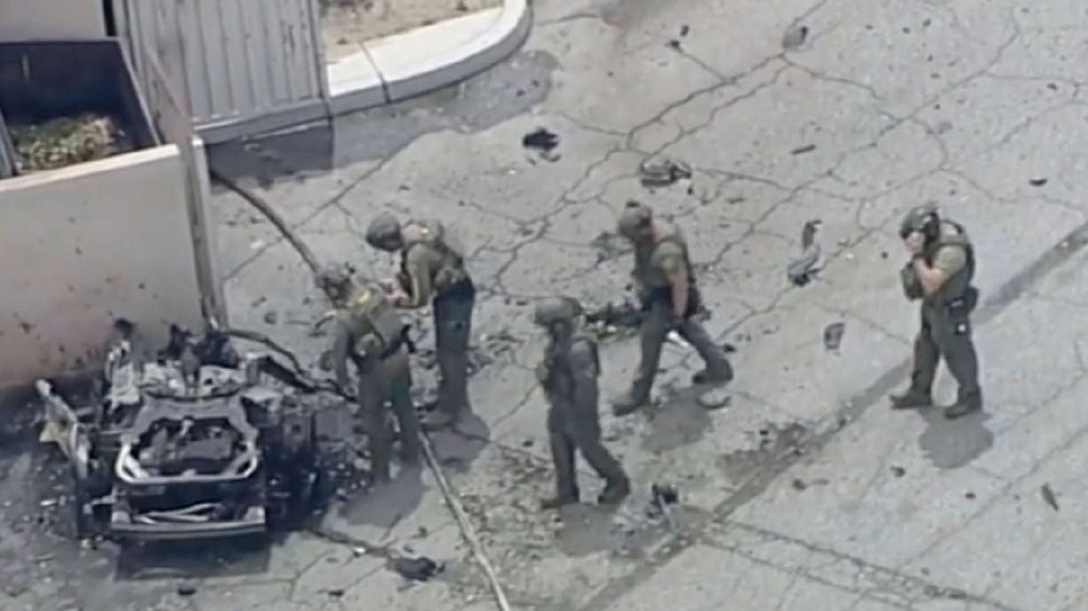 Law enforcement investigate a vehicle after an explosion on Saturday in Palm Springs, Calif. Police say the suspect left behind "anti-pro-life" writings before carrying out the attack.