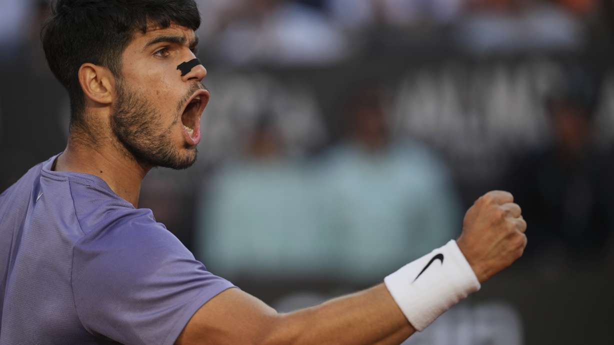 Carlos Alcaraz of Spain, reacts after scoring a point against Jannik Sinner of Italy during their final tennis match in the Italian Open at the Foro Italico in Rome, Sunday, May 18, 2025.