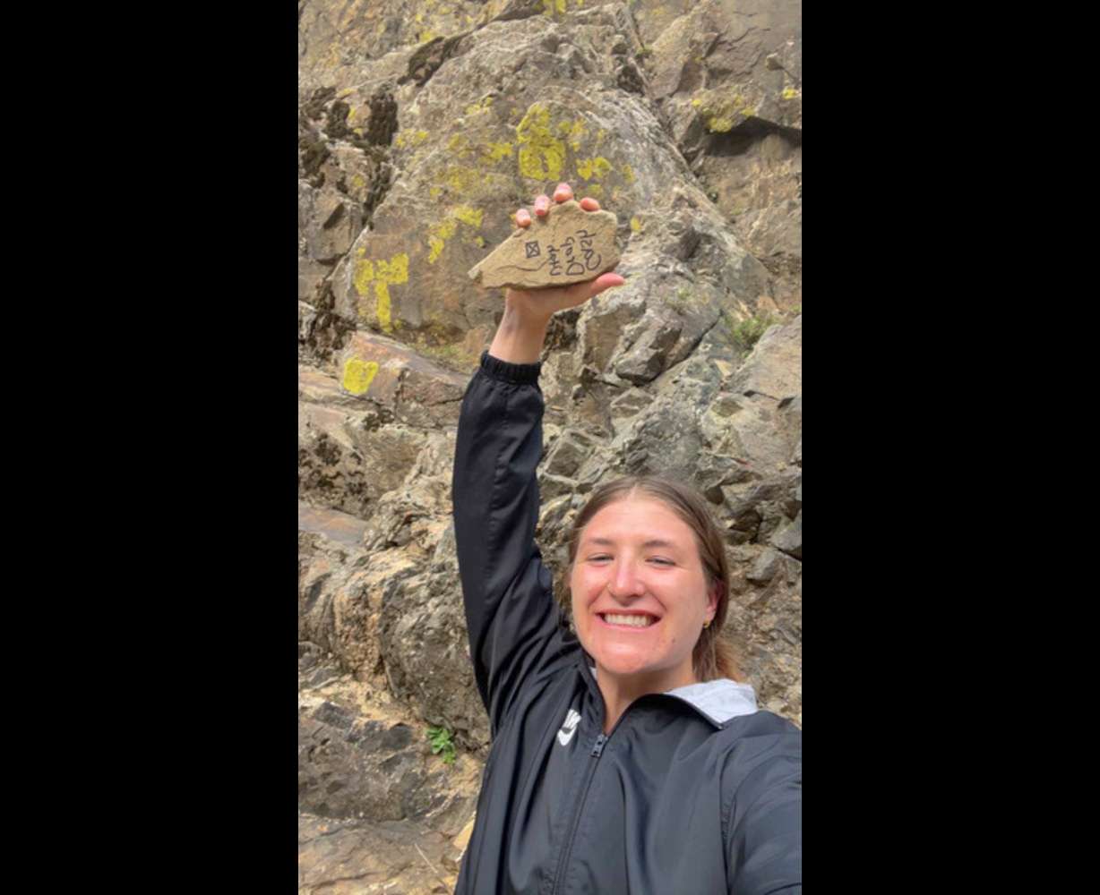Maliah Robinson, the winner of the $3,000 drop in April, shows off a clue she found in the form of a rock.