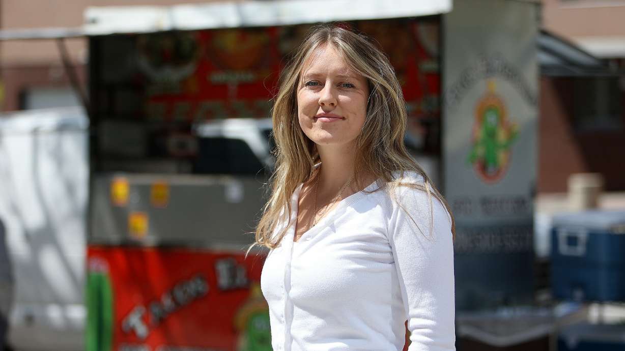 Megan Akar poses for a photo by the Tacos El Potosino food truck in Salt Lake City on May 1. Akar keeps a running tab with the food truck to pay for meals for homeless people.