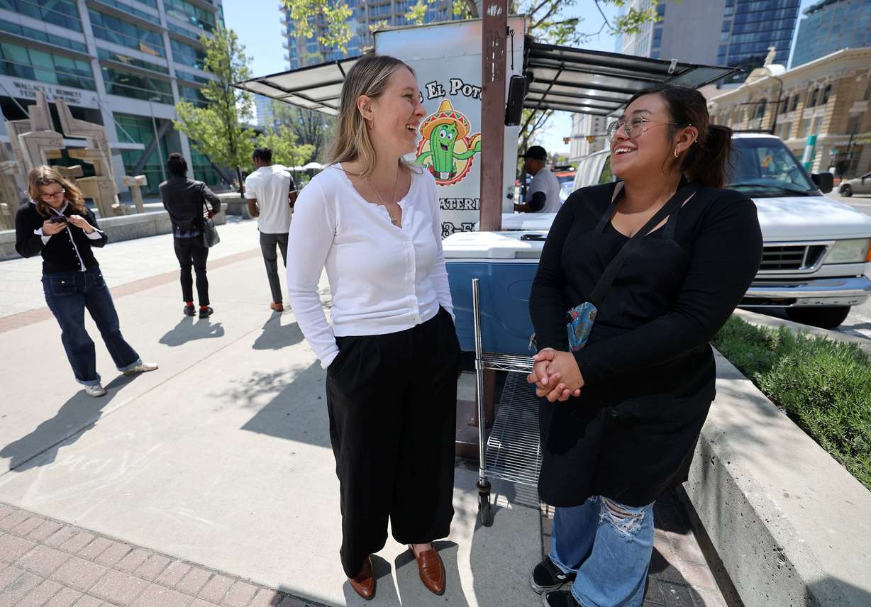 Megan Akar talks with Emely Garcia, who works for the Tacos El Potosino food truck, outside of the Wallace F. Bennett Federal Building, where Akar works, in Salt Lake City on May 1. Akar keeps a running tab with the food truck to pay for meals for homeless people.
