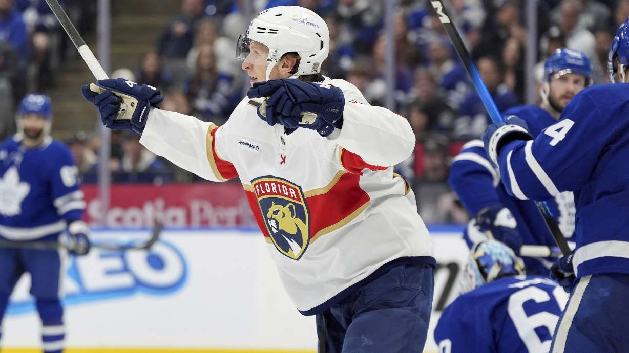 Florida Panthers center Eetu Luostarinen, center, celebrates after scoring against Toronto Maple Leafs goaltender Joseph Woll (60) during the third period of Game 7 of a second-round NHL hockey playoff series in Toronto, Sunday, May 18, 2025.
