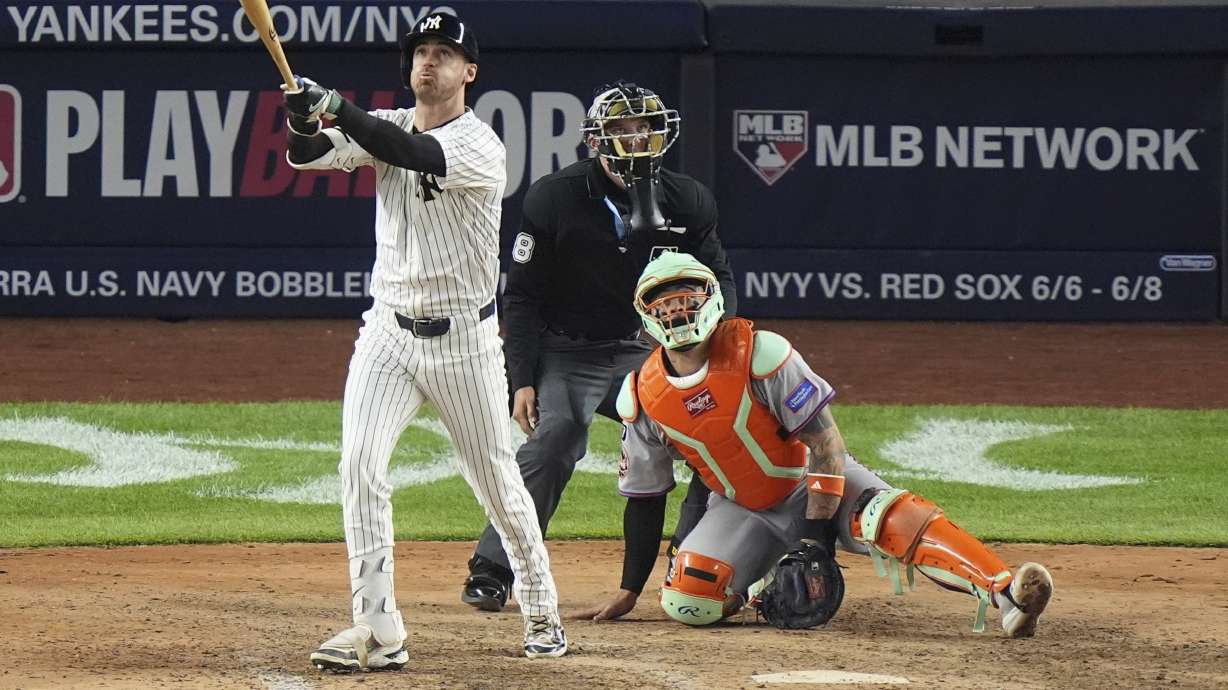 New York Mets catcher Francisco Alvarez, right, watches New York Yankees' Cody Bellinger follows through on a grand slam during the eighth inning of a baseball game Sunday, May 18, 2025, in New York.