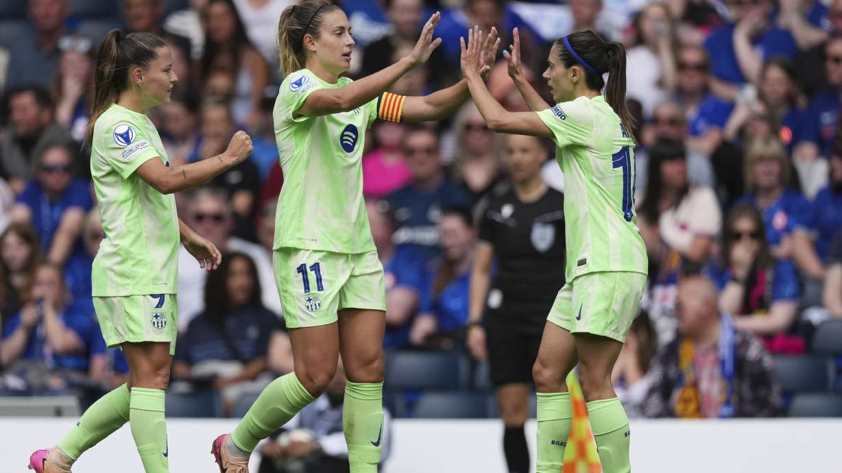 Barcelona's Aitana Bonmati celebrates with teammates Alexia Putellas, center, and Claudia Pina, left, after scoring the opening goal during the women's Champions League semifinals, second leg, soccer match between Chelsea FC and FC Barcelona at Stamford Bridge in London, Sunday, April 27, 2025.