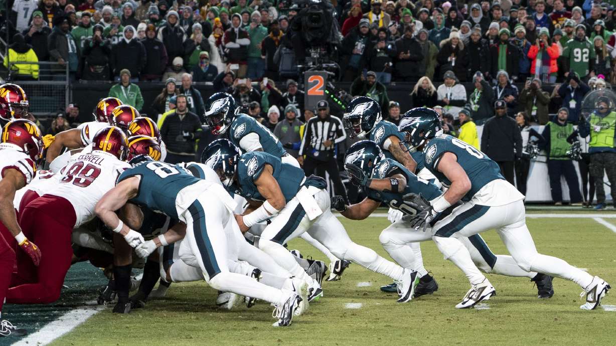 FILE - Philadelphia Eagles quarterback Jalen Hurts, center, and teammates run the tush push play during the NFL championship playoff football game against the Washington Commanders, Sunday, Jan. 26, 2025, in Philadelphia.