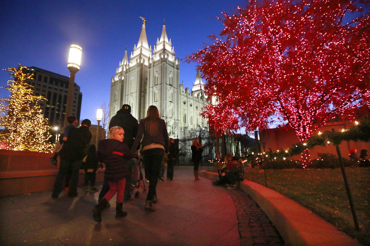 Pedestrians check out the lights on the trees at Temple Square in Salt Lake City on Nov. 28, 2014.