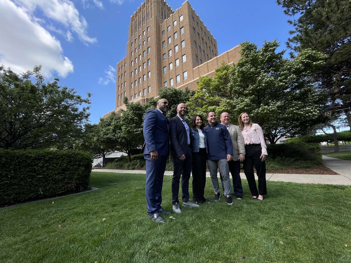Brad Wilson, third from right, and other officials helping organize the 2034 Winter Olympics in Utah met with leaders in Ogden on Monday to discuss local efforts. They're pictured outside the Ogden Municipal Building.