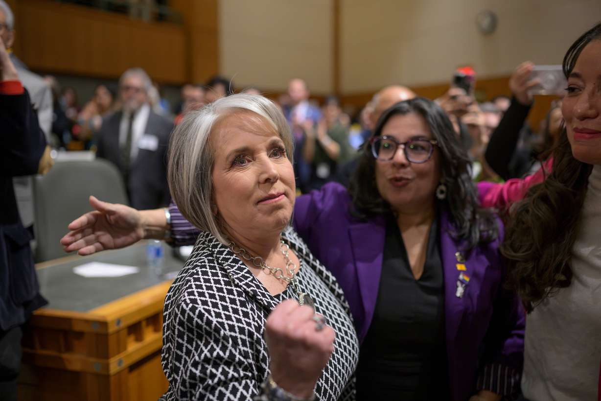 New Mexico Gov. Michelle Lujan Grisham enters the House Chambers to deliver her State of the State speech at the Capitol, in Santa Fe, N.M., Jan. 16, 2024. Grisham and Utah Gov. Spencer Cox on Monday explained how social polarization, performative politics and a loneliness epidemic created incentives ripe for dysfunction.