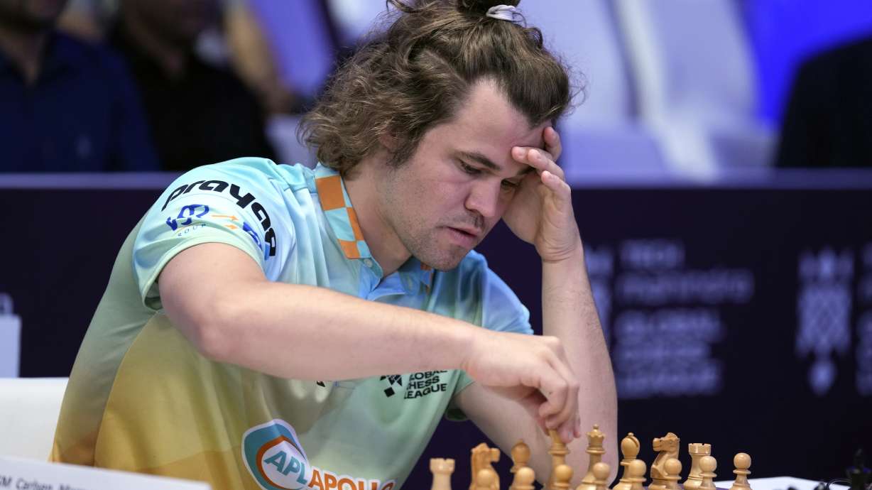 Norwegian Magnus Carlsen, left, plays in a Global Chess League in Dubai United Arab Emirates, on July 1, 2023. Carlsen was forced into a draw Monday by more than 143,000 people worldwide.