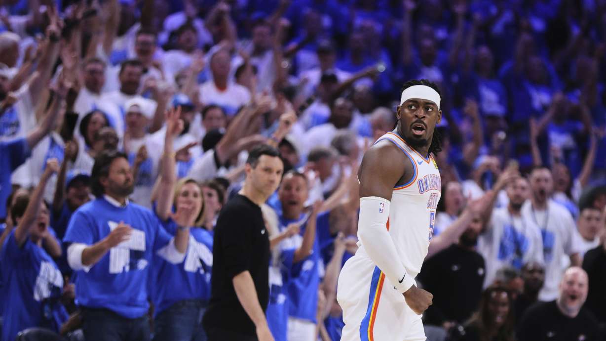 Fans cheer as Oklahoma City Thunder's Luguentz Dort celebrates sinking a three-pointer in the second half of Game 5 of an NBA basketball second-round playoff series against the Denver Nuggets Tuesday, May 13, 2025, in Oklahoma City.