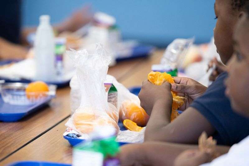 A student eats a local orange for lunch at John B. Wright Elementary School in Tucson, Ariz., April 29. The Tucson Unified School District receives federal funding for local farm produce.
