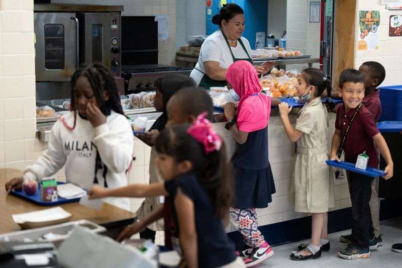 Adriana Garcia serves lunch to students at John B. Wright Elementary School in Tucson, Ariz., April 29. The Tucson Unified School District receives federal funding for local farm produce.