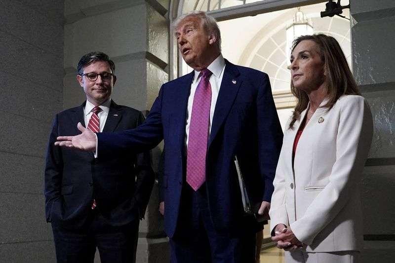 President Donald Trump, U.S. House Speaker Mike Johnson, R-LA, and House Republican Conference Chair Lisa McClain, R-MI, speak to members of the media on the day of a closed House Republican Conference meeting on Capitol Hill in Washington, Tuesday.