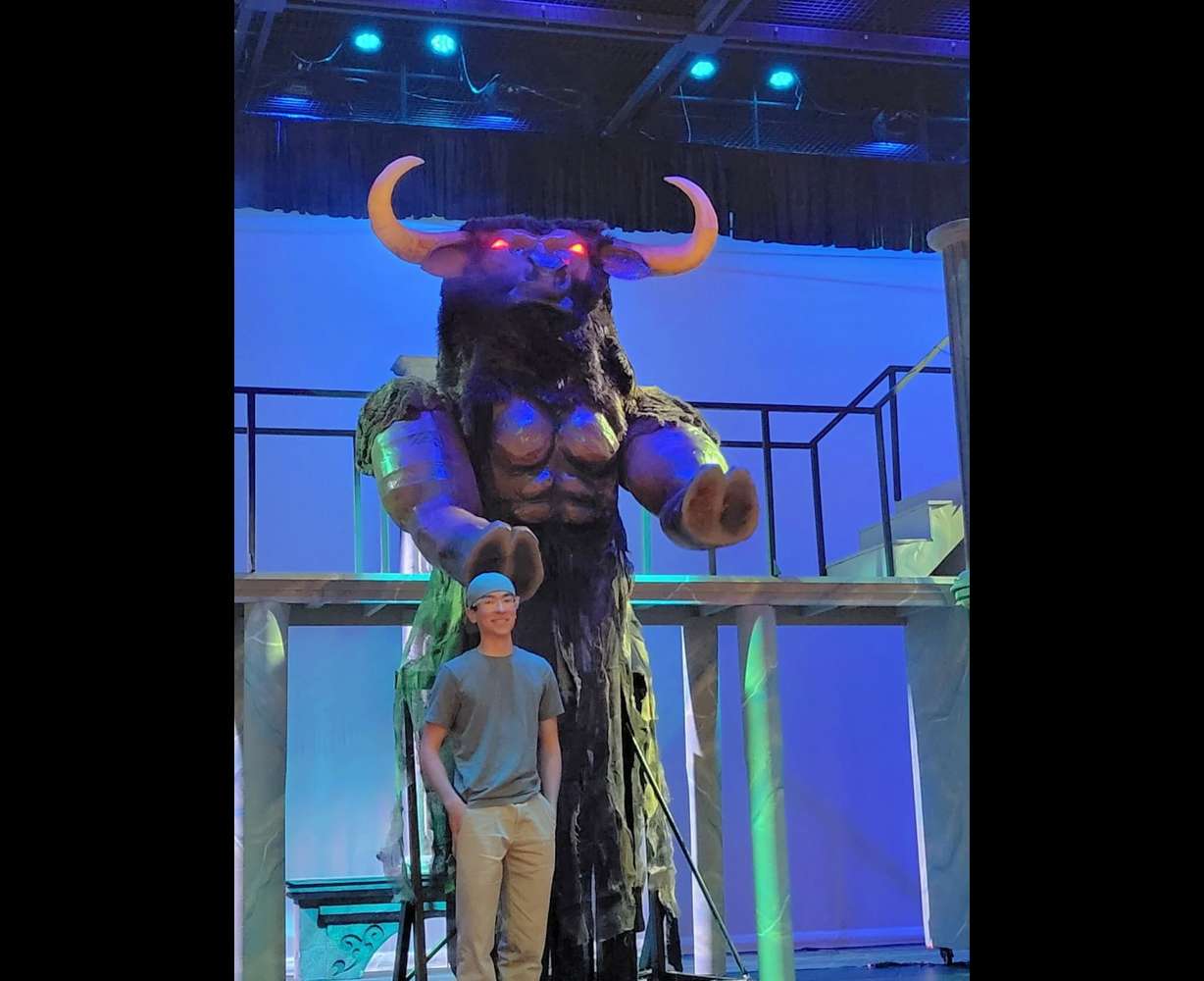 Tyson Duran, a ninth grader at Vista School, stands with the large robot he built for his school's play, date not specified, Ivins, Utah.