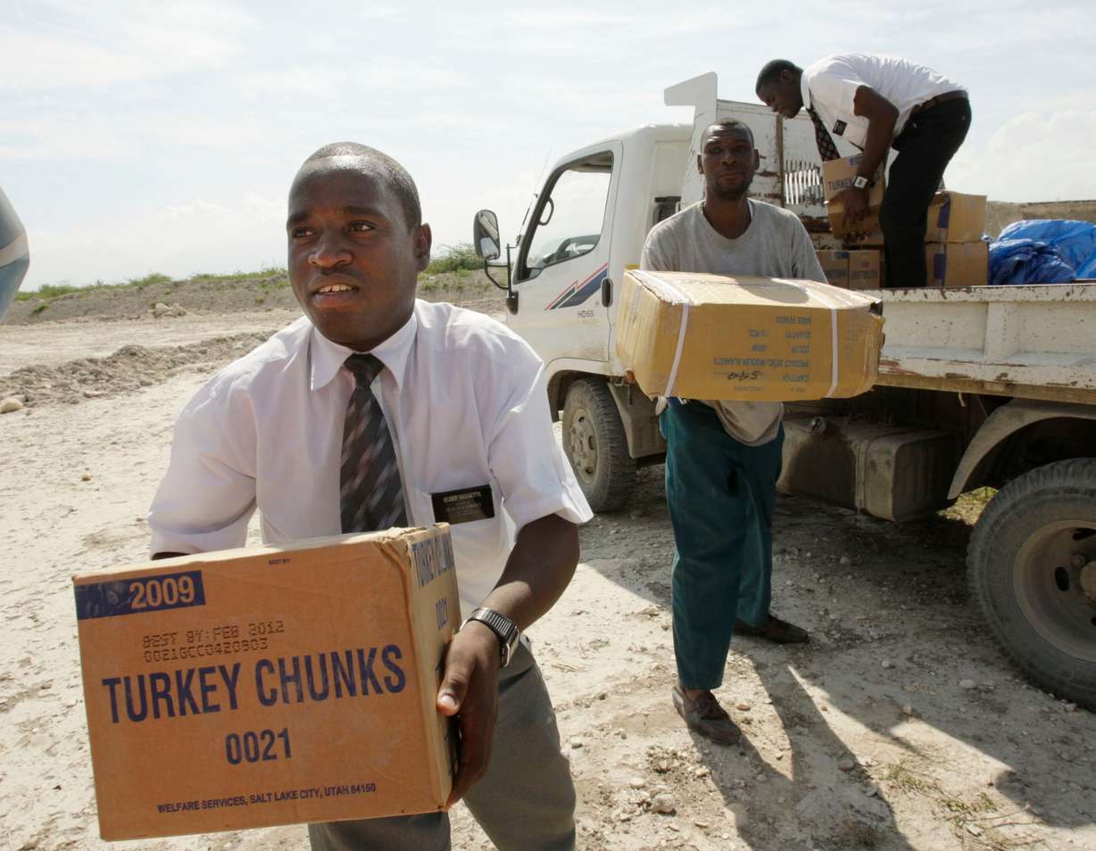 Elder Sammuel Bassette, left, and Elder Lgune Raymond, missionaries for The Church of Jesus Christ of Latter-day Saints, unload supplies for victims of the earthquake in Port-au-Prince, Haiti, Jan. 20, 2010.