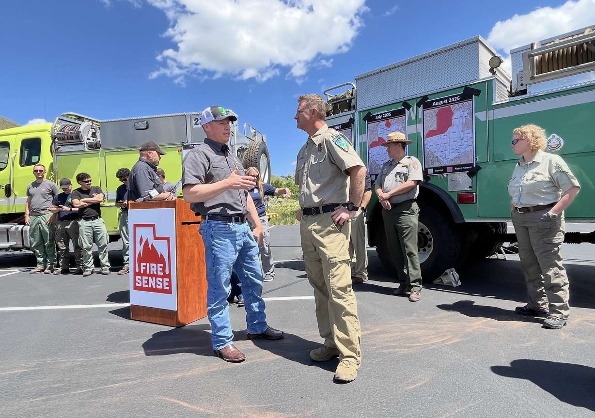 Joel Ferry, director of the Utah Department of Natural Resources, left, and Chris Delaney, state fire management officer for the Bureau of Land Management, right, speak before a Utah Fire Sense press conference at This is the Place State Park in Salt Lake City on Tuesday.
