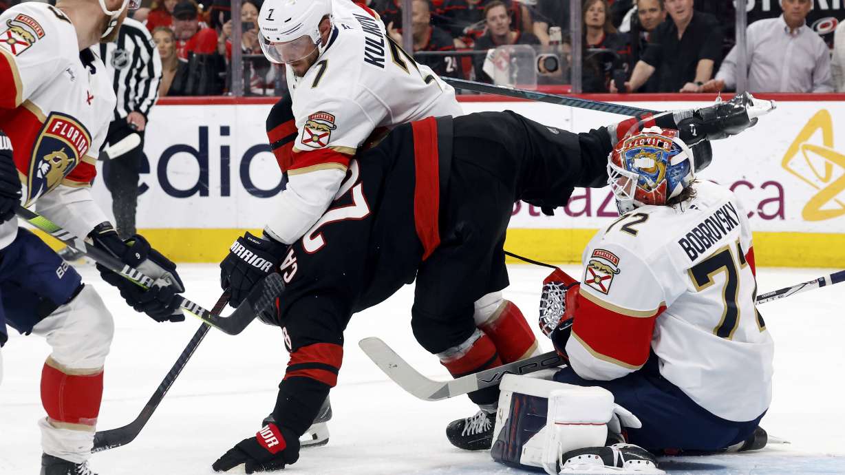 Carolina Hurricanes' William Carrier (28) gets pushes into Florida Panthers goaltender Sergei Bobrovsky (72) by Dmitry Kulikov (7) during the second period of Game 1 of the NHL hockey Stanley Cup Eastern Conference finals in Raleigh, N.C., Tuesday, May 20, 2025.