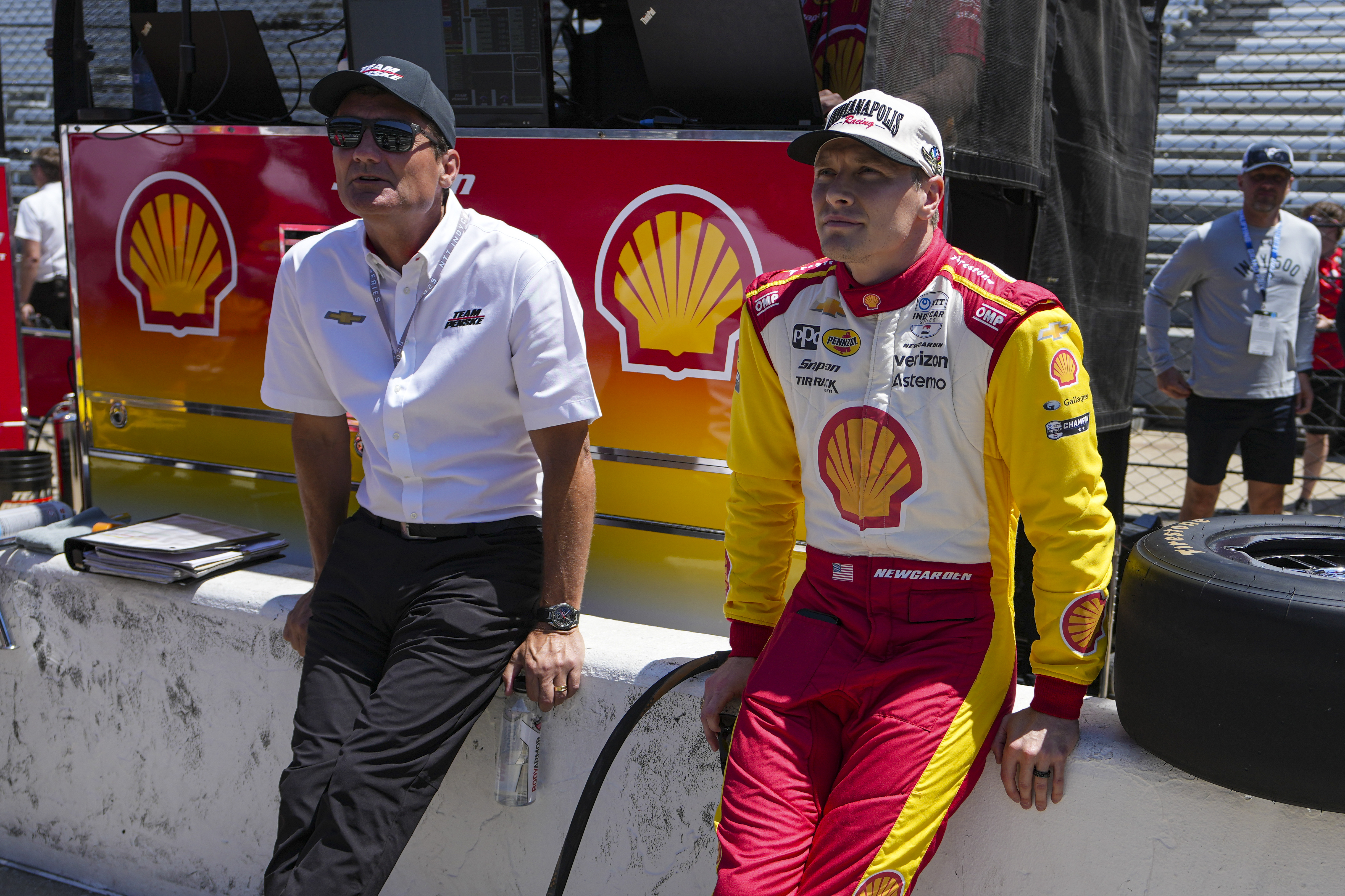 President of Team Penske Tim Cindric, left and driver Josef Newgarden wait for the start of during practice for the Indianapolis 500 auto race at Indianapolis Motor Speedway in Indianapolis, Sunday, May 18, 2025.