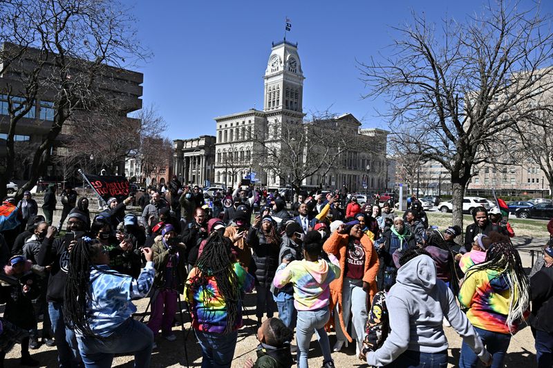 People dance at a gathering to mark two years since police officers shot and killed Breonna Taylor when they entered her home, at Jefferson Square Park in Louisville, Ky., March 13, 2022.
