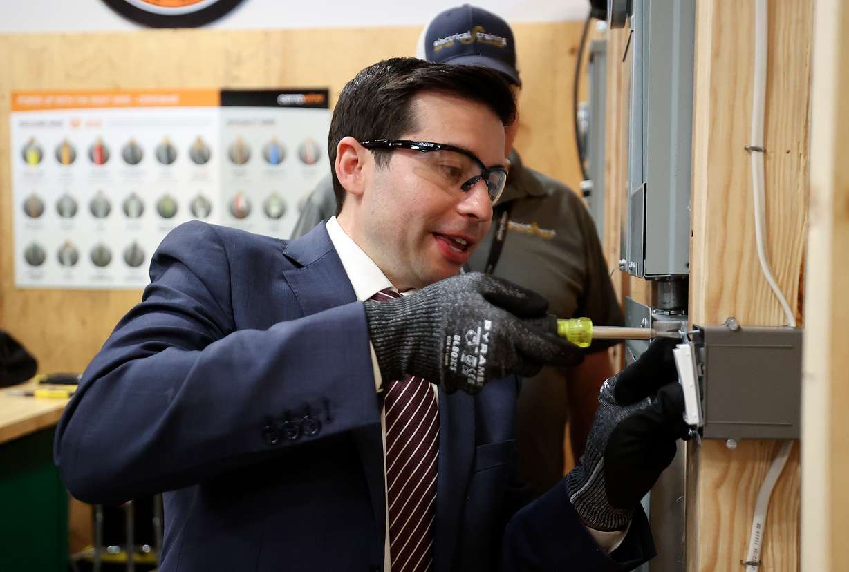 U.S. Deputy Secretary of Labor Keith E. Sonderling installs a light switch while visiting Utah Electrical Training Alliance in West Jordan on Wednesday.