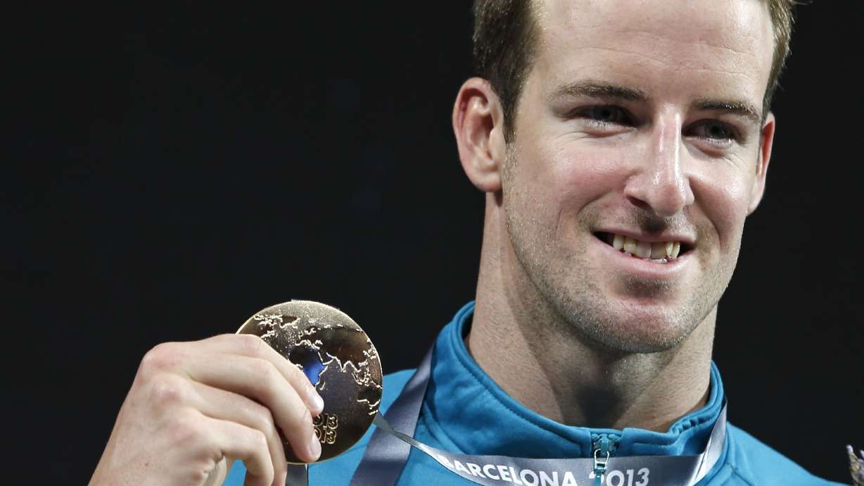 FILE - Australia's James Magnussen smiles as he hold the gold medal he won in the Men's 100m freestyle final at the FINA Swimming World Championships in Barcelona, Spain, on Aug. 1, 2013.