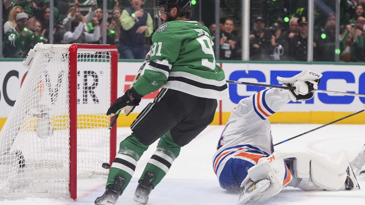 Dallas Stars center Tyler Seguin (91) scores a goal against Edmonton Oilers goaltender Stuart Skinner (74) during the first period in Game 1 of the Western Conference finals in the NHL hockey Stanley Cup playoffs against the Dallas Stars, Wednesday, May 21, 2025, in Dallas.