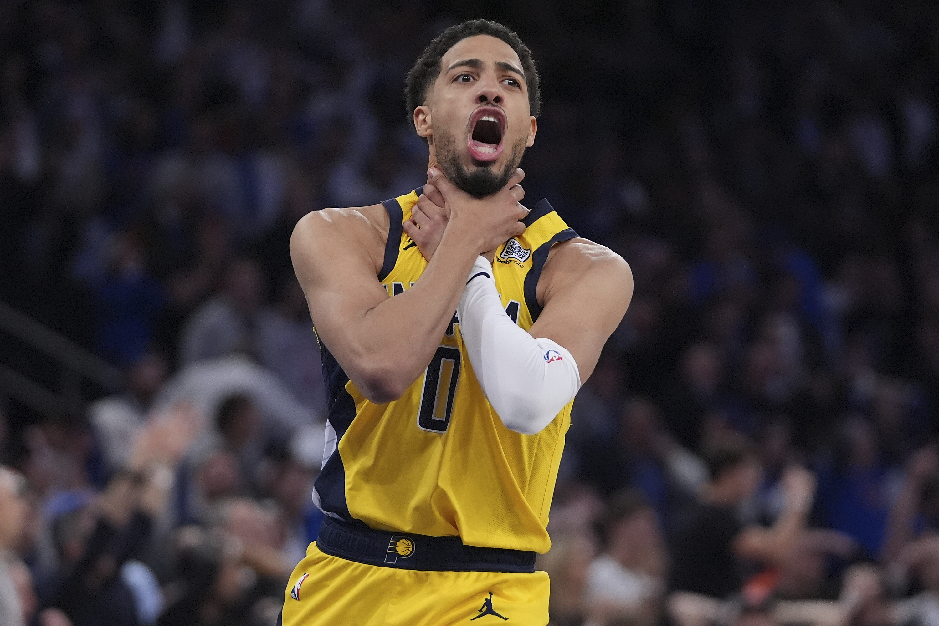 Indiana Pacers guard Tyrese Haliburton (0) makes a choke motion towards the New York Knicks after hitting a shot at the end of the fourth quarter of Game 1 of the NBA basketball Eastern Conference final, Wednesday, May 21, 2025, in New York.