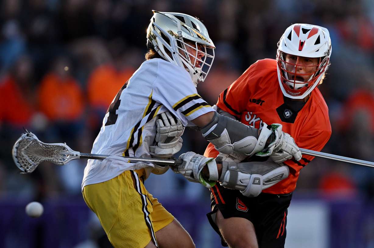 Skyridge’s Cabell Buechner shoots past Davis’ Luke Nosler as they play in 5A Boys Lacrosse semifinals at Westminster University in Salt Lake City on Wednesday, May 21, 2025.
