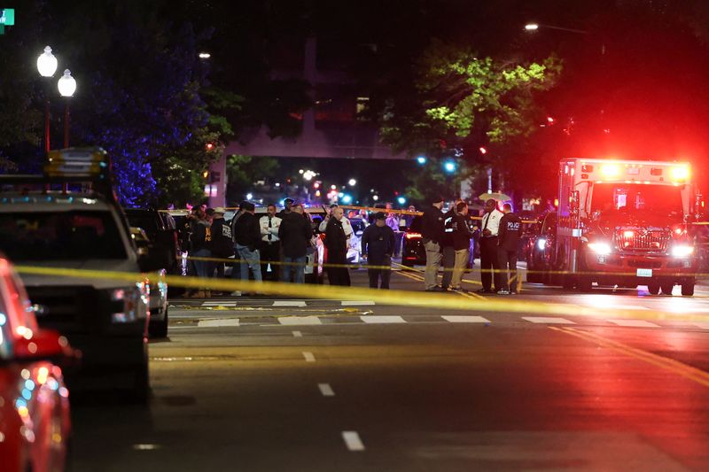 Emergency personnel work at the site where, according to the Homeland Security Secretary, two Israeli embassy staff were shot dead near the Capital Jewish Museum in Washington, D.C., Wednesday.