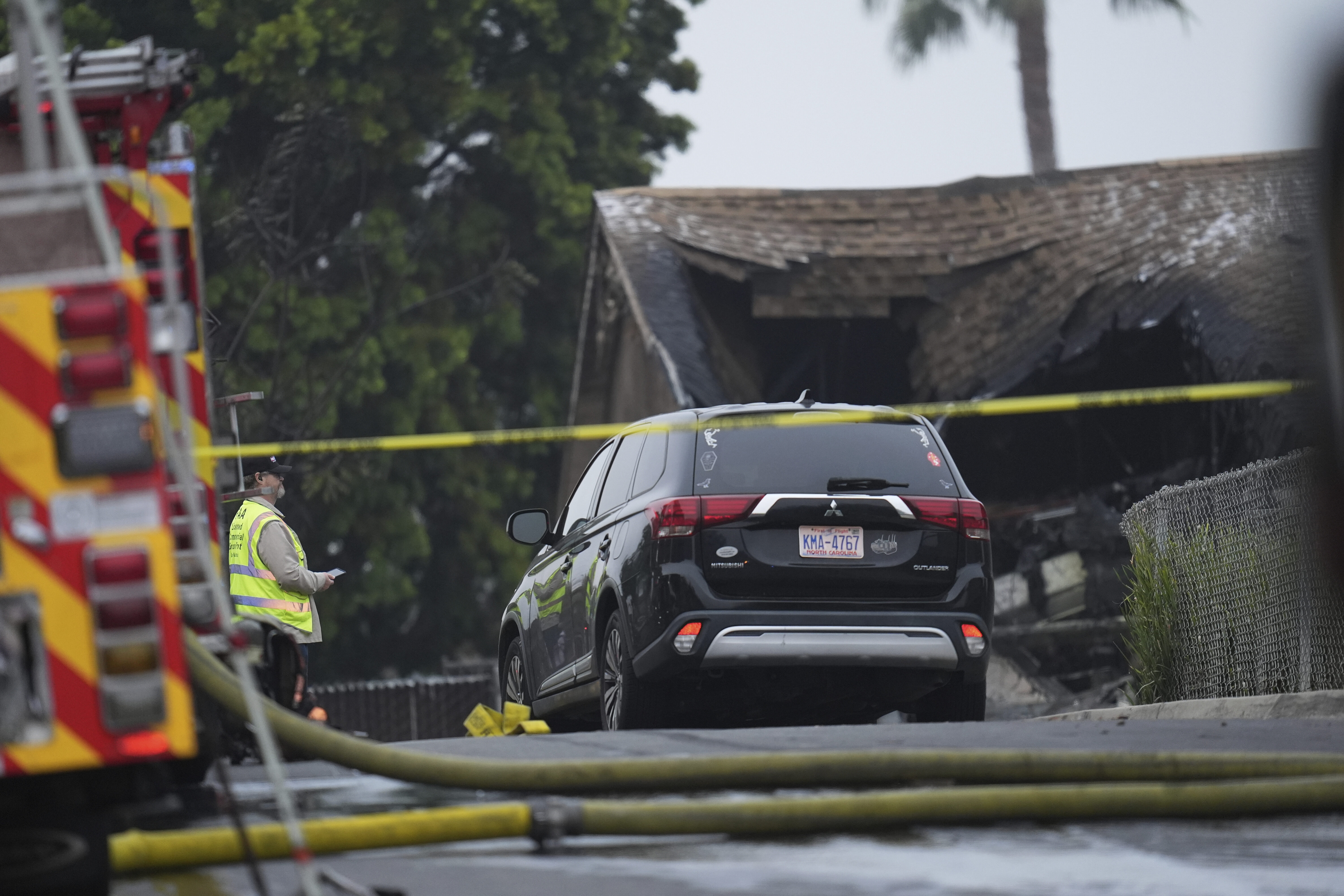 Authorities work the scene where a small plane crashed into a San Diego neighborhood, setting several homes on fire and forcing evacuations along several blocks early Thursday.