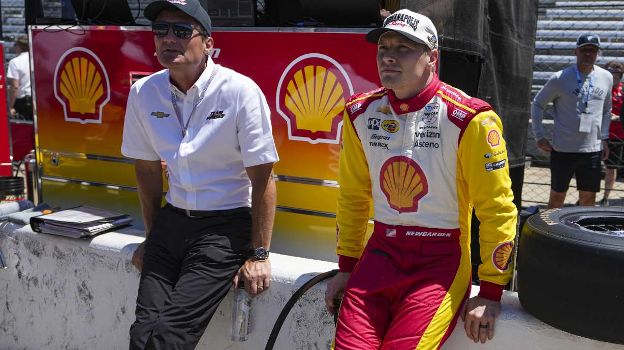 President of Team Penske Tim Cindric, left and driver Josef Newgarden wait for the start of during practice for the Indianapolis 500 auto race at Indianapolis Motor Speedway in Indianapolis, Sunday, May 18, 2025.