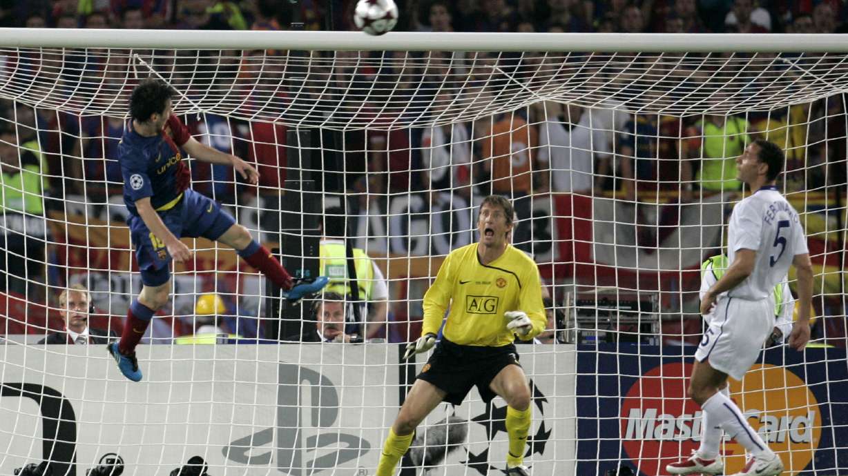 FILE - Barcelona's Lionel Messi, left, scores on a header during the UEFA Champions League final soccer match between Manchester United and Barcelona in Rome, May 27, 2009.