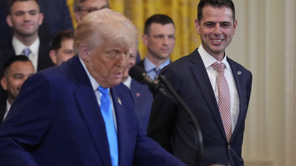 President Donald Trump speaks as he hosts the 2025 NCAA Champion, University of Florida men's basketball team in the East Room of the White House, Wednesday, May 21, 2025, in Washington, as head coach Todd Golden, listens at right.