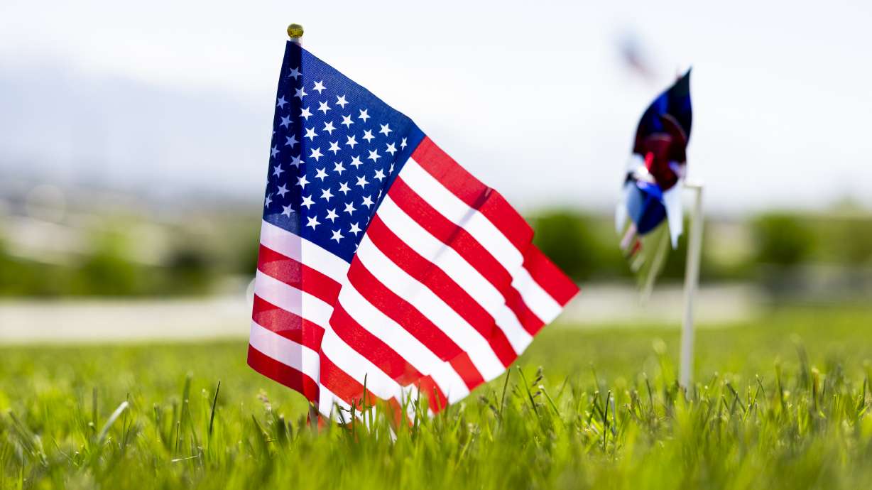 An American flag is posted at a grave at the Utah Veterans Cemetery and Memorial Park in Bluffdale on May 21, 2025. The development of a planned veterans cemetery in Utah is advancing, now with funding from the U.S. Department of Veterans Affairs.