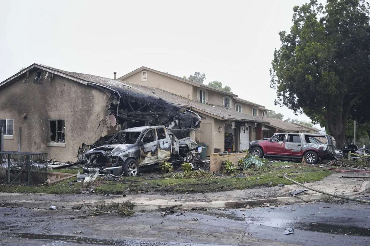 Vehicles and houses are damaged after a small plane crashed into a San Diego, Calif., neighborhood, setting several homes on fire and forcing evacuations along several blocks early Thursday.