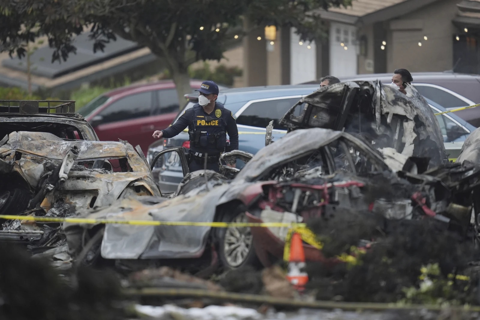 Authorities work the scene where a small plane crashed into a San Diego, Calif., neighborhood, setting several homes on fire and forcing evacuations along several blocks early Thursday.