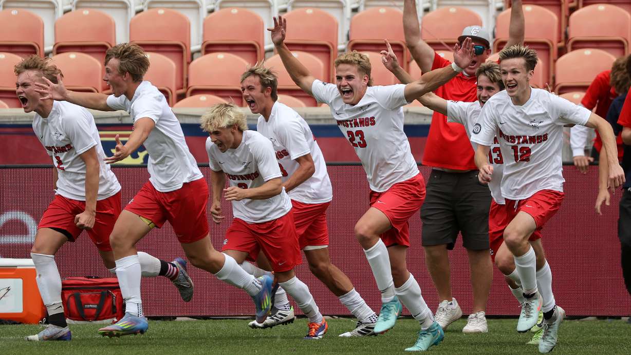 Crimson Cliffs players rush the field after winning the boys 6A state soccer championship game against Dixie at America First Field in Sandy on Thursday, May 22, 2025. Crimson Cliffs won 3-0.