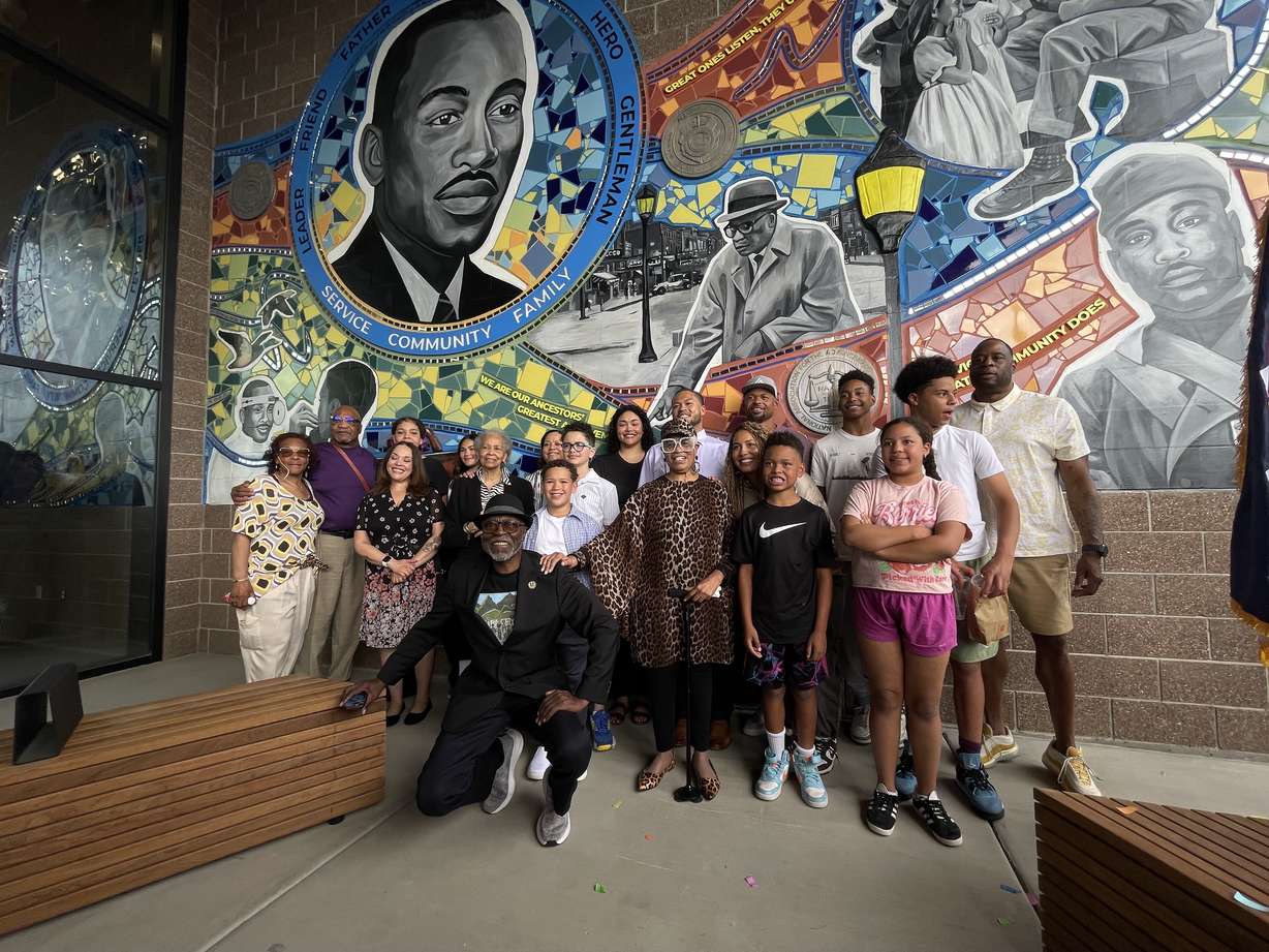 Ogden leaders unveiled the new Marshall White Center on Thursday. Family members of White pose in front of a mural that features the namesake for the facility.
