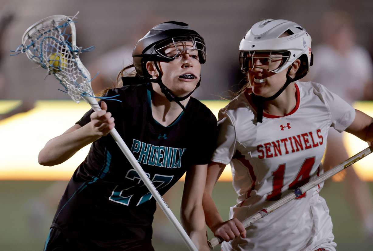 Farmington’s Alexandra MacAulay and Mountain Ridge’s Taylie Anderson compete in the 6A girls lacrosse state championship game at Zions Bank Stadium in Herriman on Thursday, May 22, 2025.