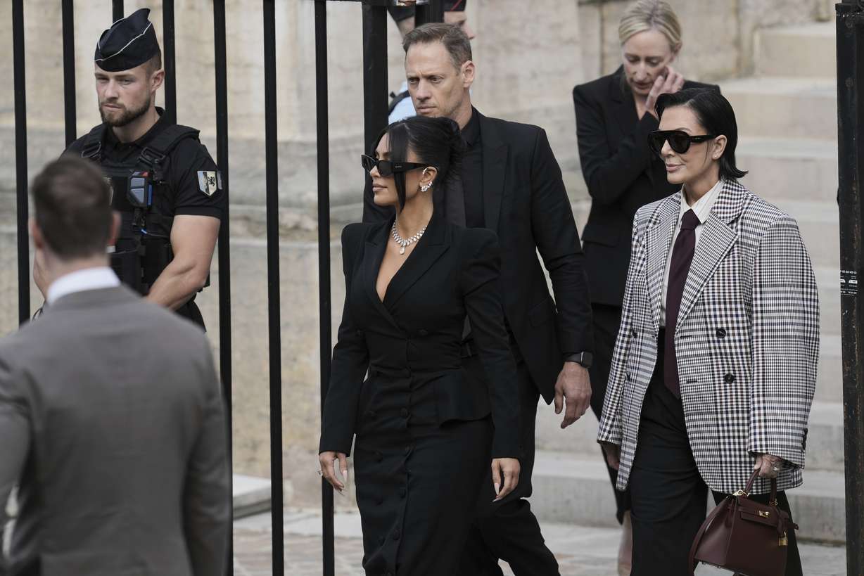 Kim Kardashian, center, accompanied by her mother Kris Jenner, right, leaves the justice palace after testifying, regarding a robbery of millions of dollars in jewels from her Paris hotel room in 2016, in Paris, May 13.