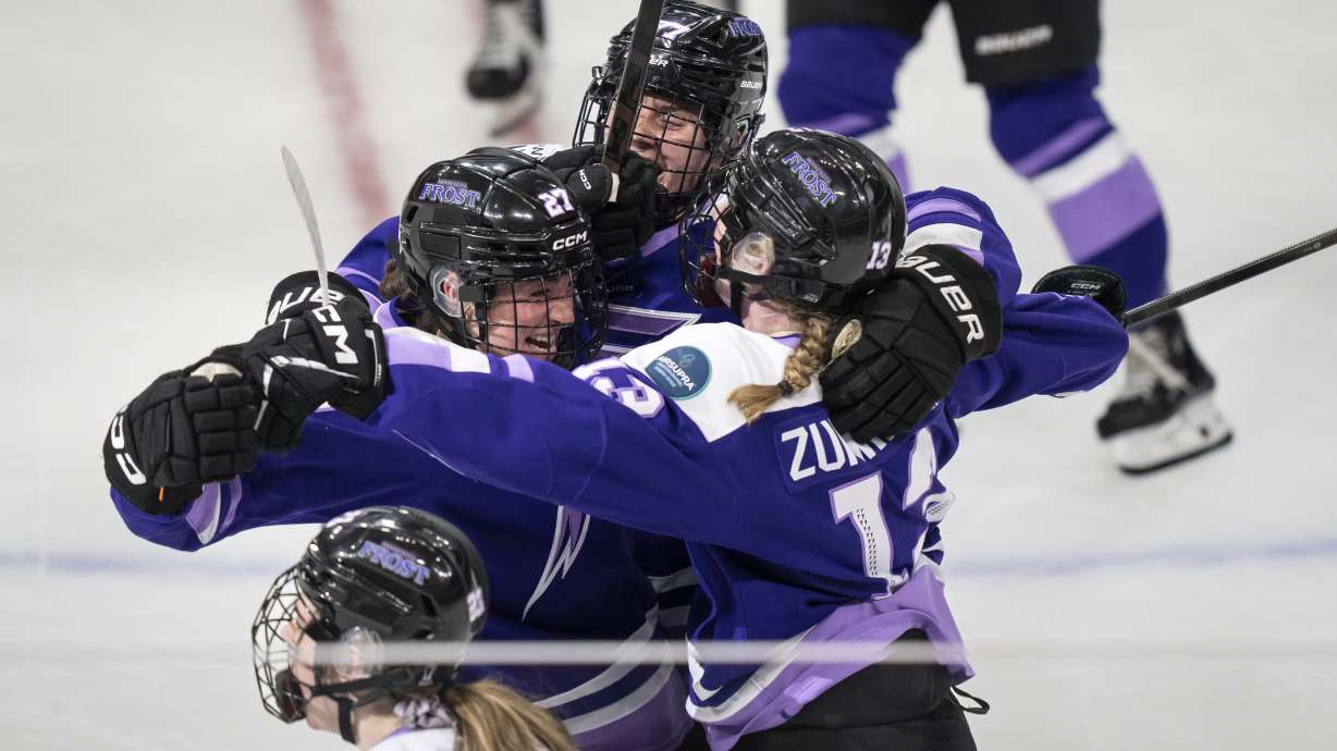 Minnesota Frost forward Taylor Heise (27), left, is surrounded by teammates, Minnesota Frost forward Britta Curl (77) and Minnesota Frost forward Grace Zumwinkle (13) after she scored the winning goal in overtime of the PWHL Walter Cup in St. Paul, Minn., on Wednesday, May 14, 2025.