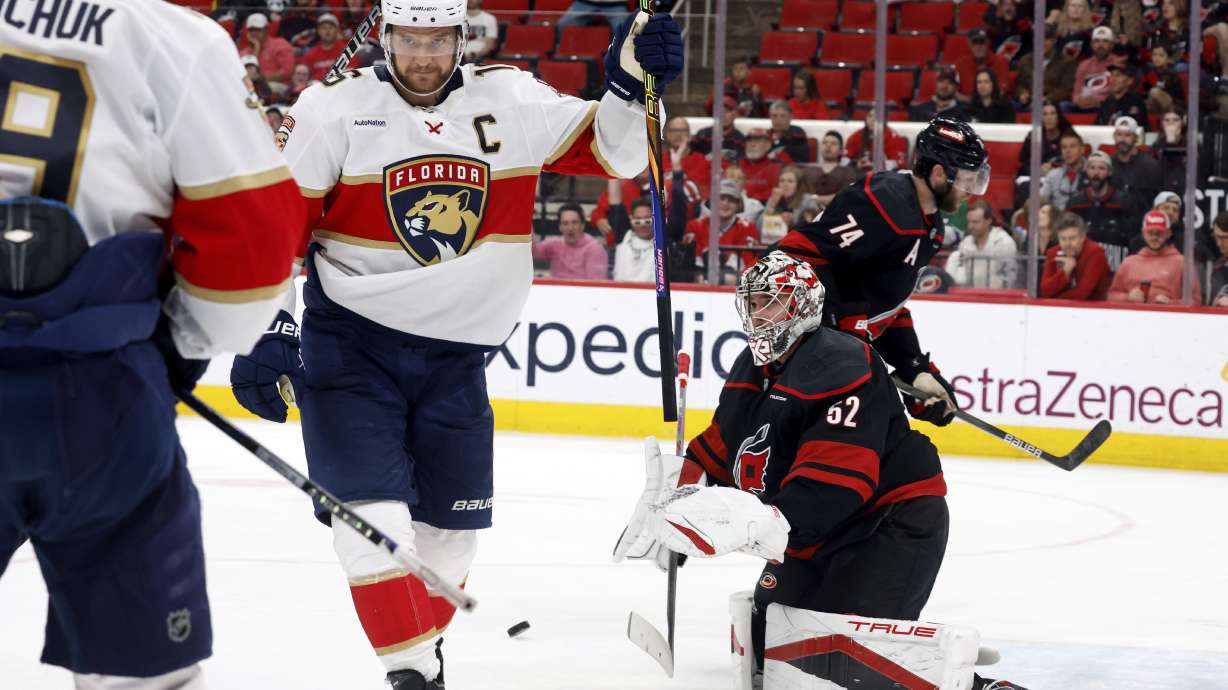 Florida Panthers' Aleksander Barkov, right, celebrates his goal with Florida Panthers' Matthew Tkachuk (19) as Carolina Hurricanes goaltender Pyotr Kochetkov (52) looks on during the third period of Game 2 of the NHL hockey Stanley Cup Eastern Conference finals in Raleigh, N.C., Thursday, May 22, 2025.