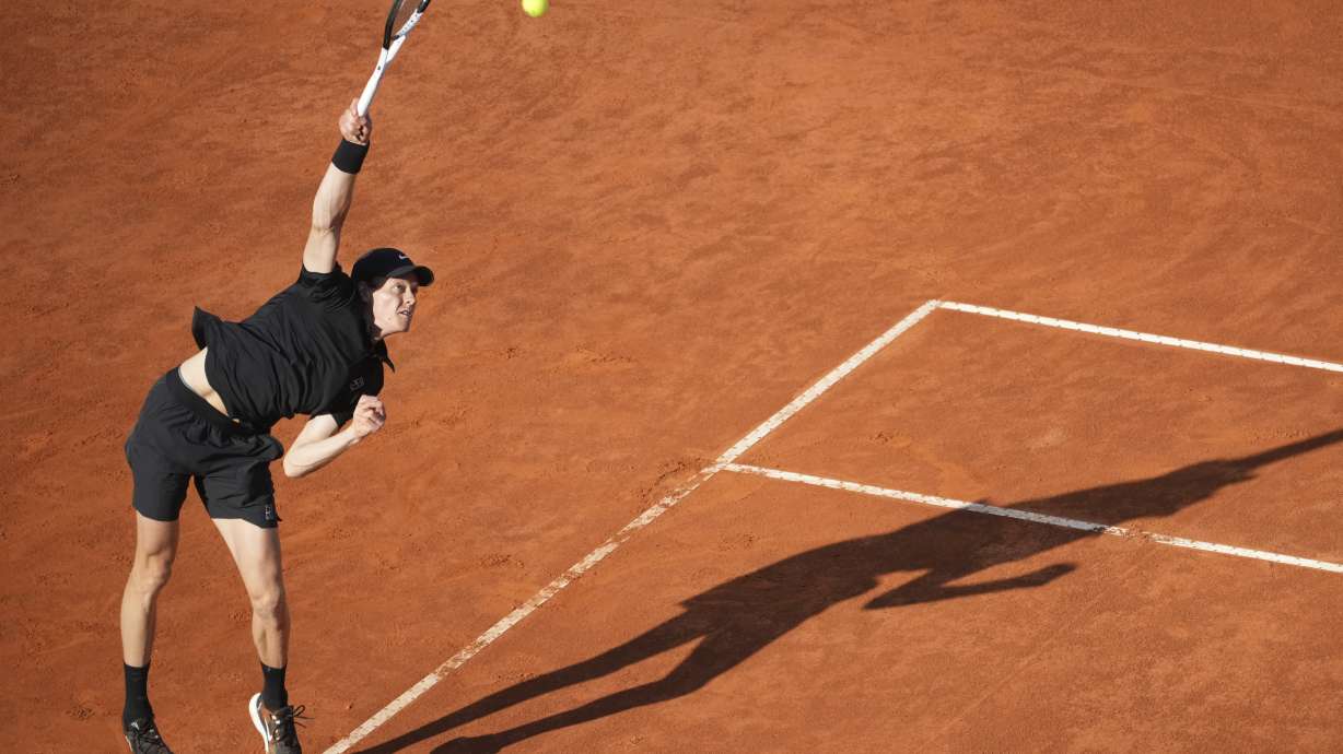 Jannik Sinner of Italy, serves against Carlos Alcaraz of Spain during their final tennis match in the Italian Open at the Foro Italico in Rome, Sunday, May 18, 2025.