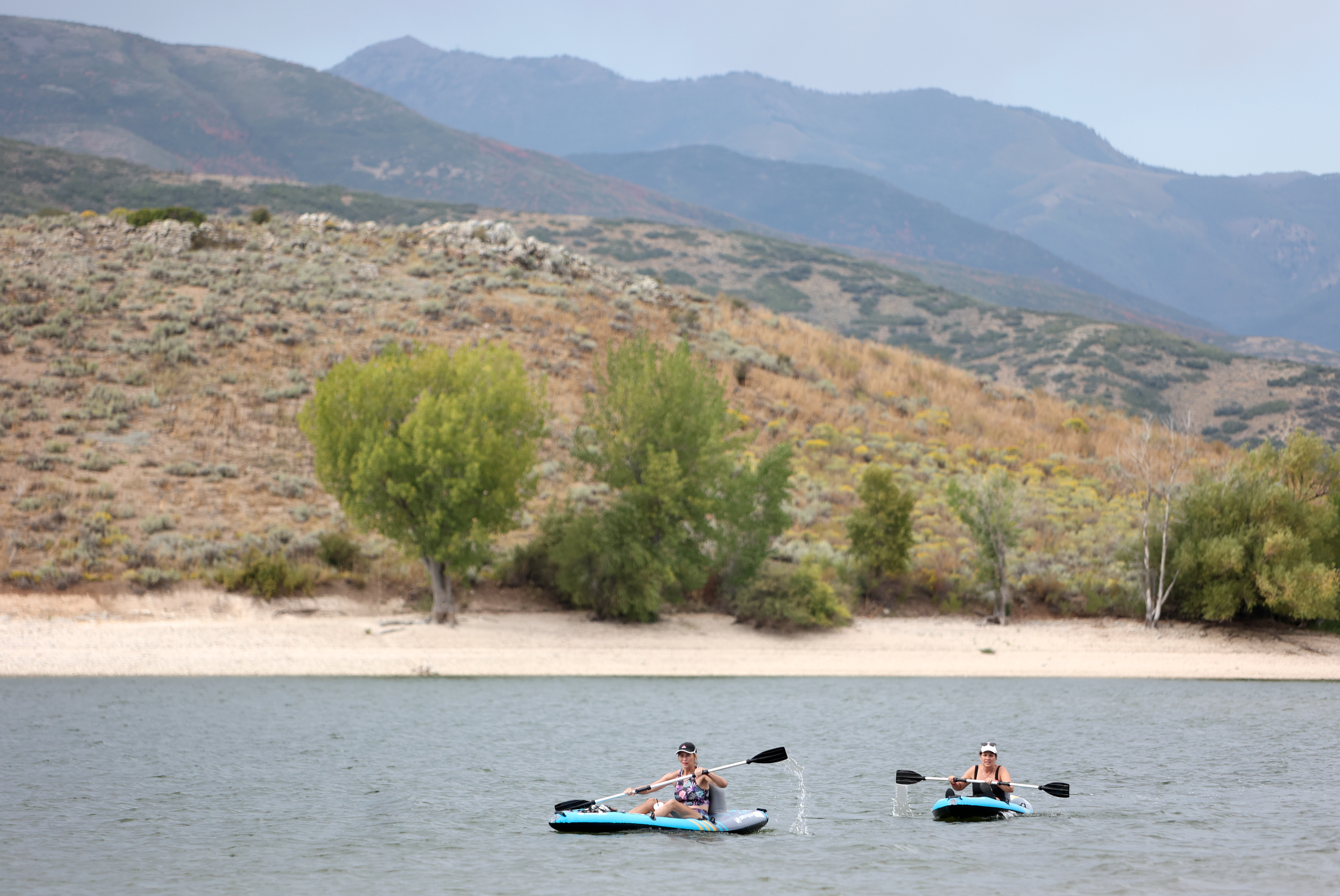 Lisa Barhoum and Nan Black kayak at Deer Creek Reservoir in Wasatch County on Sept. 9, 2024. Utah's reservoirs are looking healthy at the unofficial start of summer, but state water managers say they're tracking trends that could impact future levels.