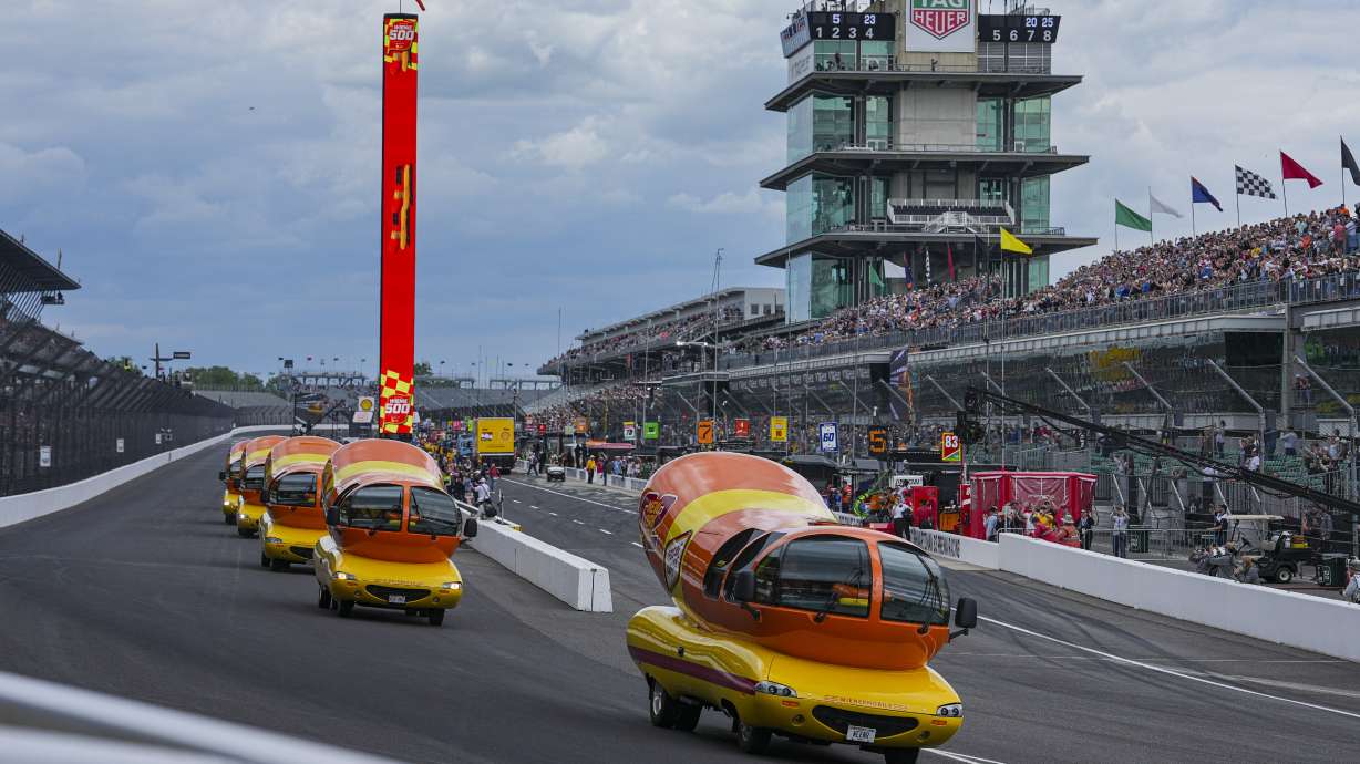 The Oscar Mayer Wienermobiles head into the first turn as they compete in the Wienie 500 following the practice session for the Indianapolis 500 auto race at Indianapolis Motor Speedway in Indianapolis, Friday, May 23, 2025.