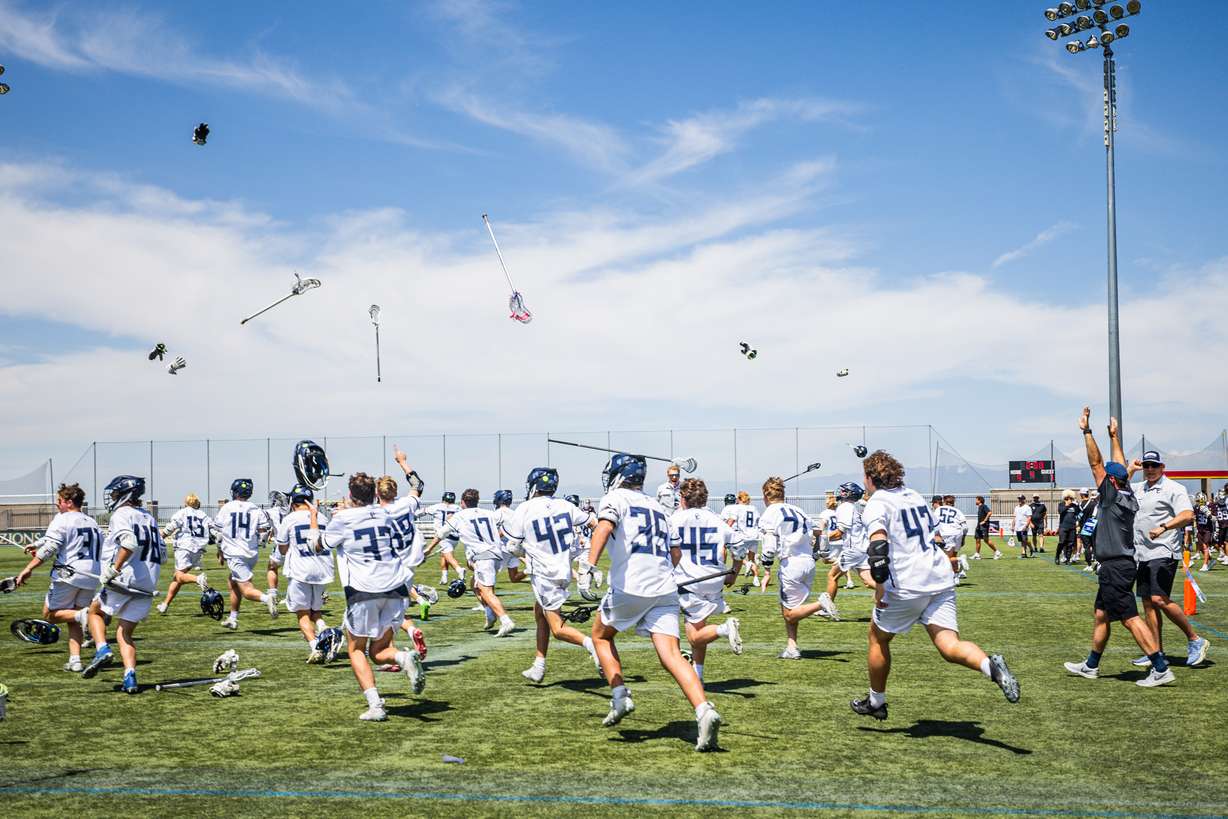 Corner Canyon Chargers players celebrate after winning the boys lacrosse 6A state championship against the Davis Darts at Zions Bank Stadium in Herriman on Friday, May 23, 2025.