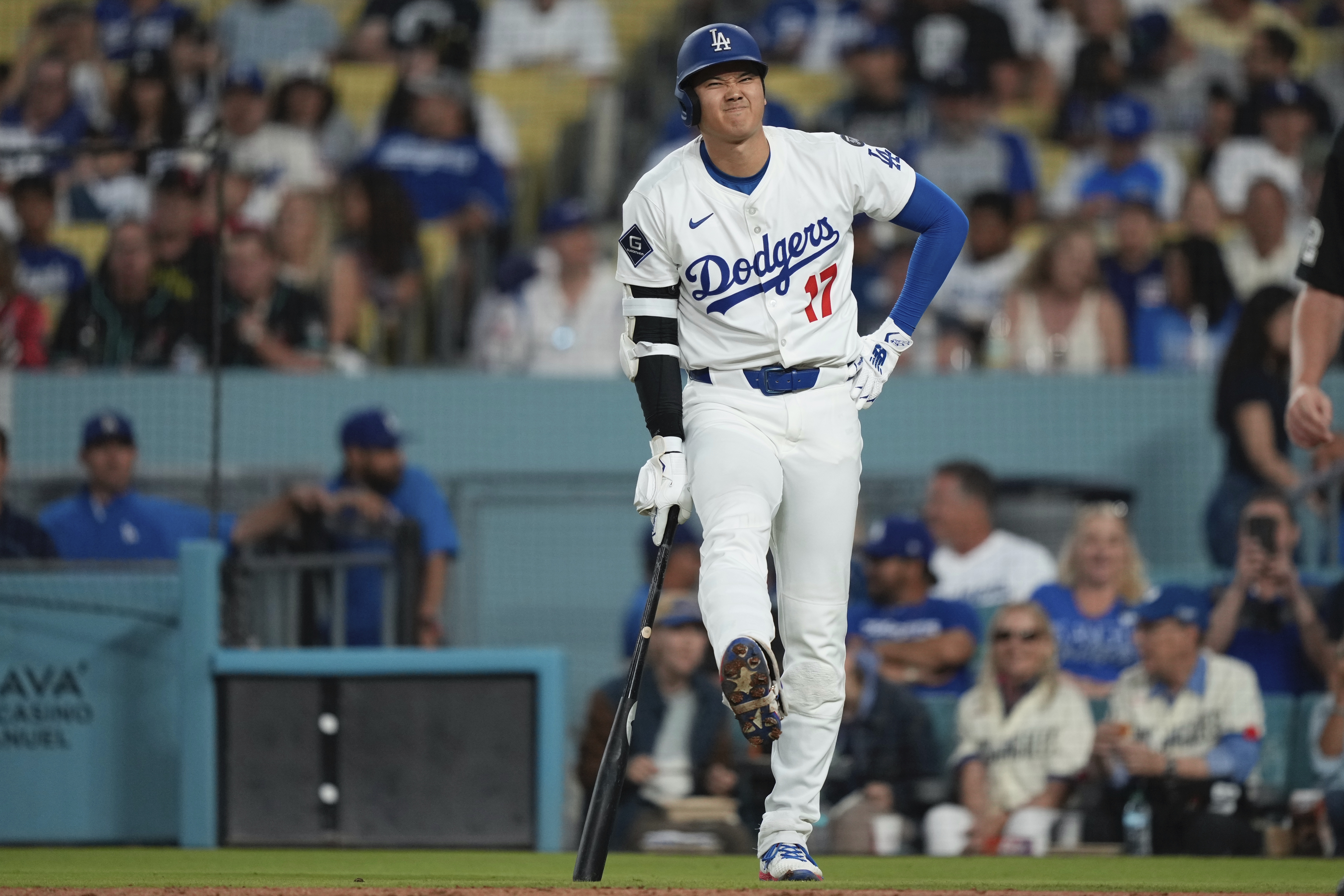 Los Angeles Dodgers' Shohei Ohtani winces after being hit with his own foul ball during the fourth inning of a baseball game against the Arizona Diamondbacks, Wednesday, May 21, 2025, in Los Angeles.