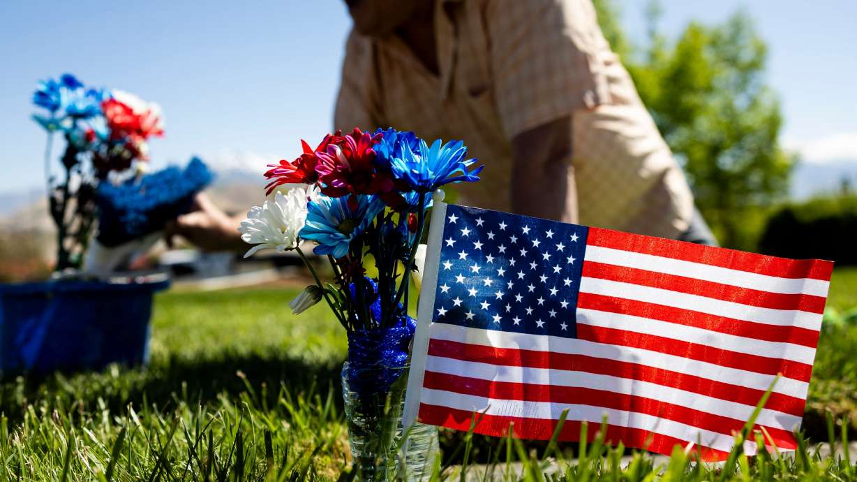 Daniel Luke, of Kaysville, tends to the grave of his father-in-law, Charles Gordon Neerings, at the Utah Veterans Cemetery and Memorial Park in Bluffdale on Wednesday. Neerings served in the U.S. Merchant Marines, Coast Guard and Army.