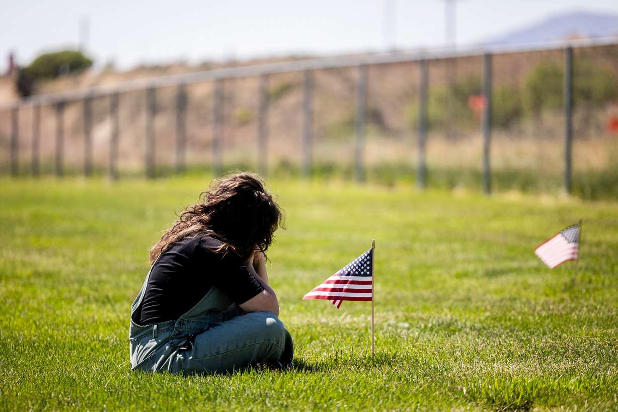 Shannon Butler, of Springville, visits the grave of her mother, Judith S. Brackett, at the Utah Veterans Cemetery and Memorial Park in Bluffdale on Wednesday.