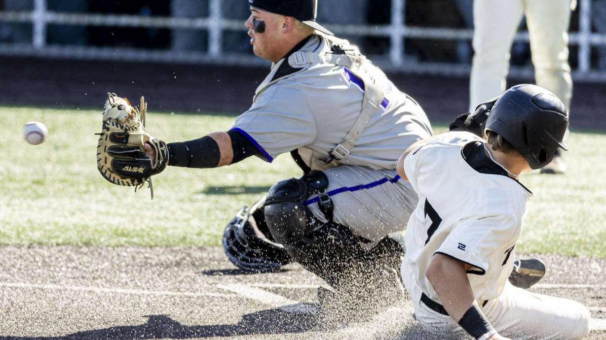 American Fork infielder Harry Gardner (7) beats the tag by Lehi catcher Brandon Manookin (15) to make the score 10-0 in the fifth inning and causing American Fork to defeat Lehi by mercy rule during the first game of the championship series in the 6A high school baseball state tournament held at UCCU Ballpark on the campus of Utah Valley University in Orem on Friday, May 23, 2025.